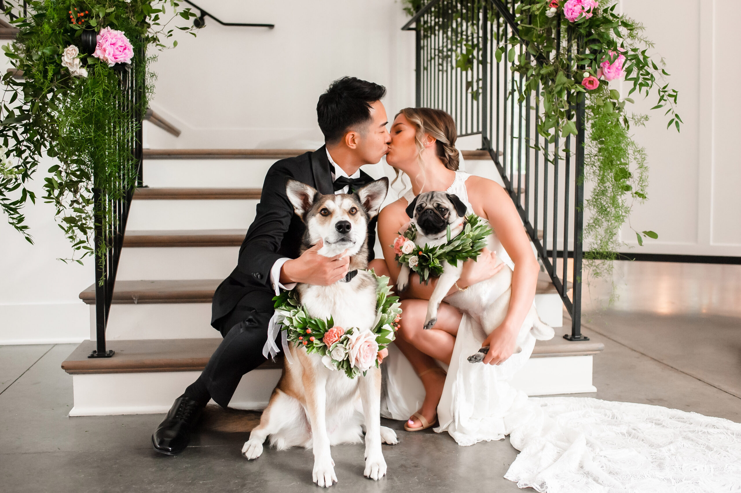 Dog-inclusive summer wedding at The Hutton House with elegant pink florals and two beloved pups wearing flower collars.